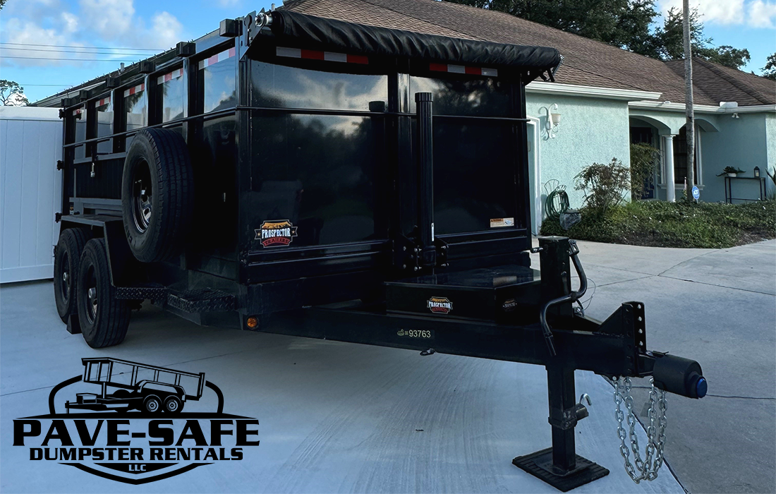 Pave-Safe Dumpster Rentals LLC Dump trailer parked in driveway at job site with Pave-Safe Dumpster Rentals LLC logo.